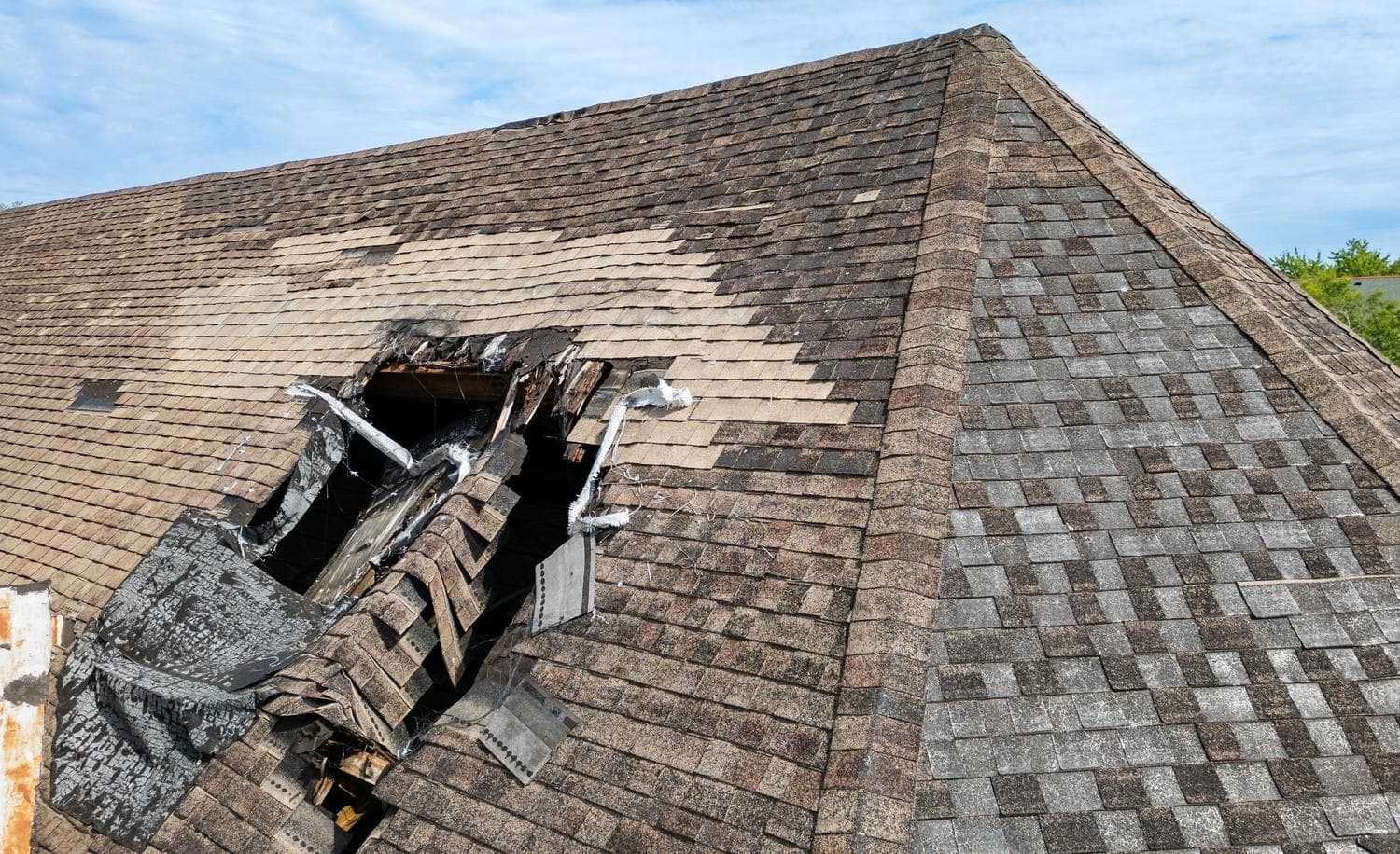 Technician repairing a leaking porch roof in Lincoln, NE