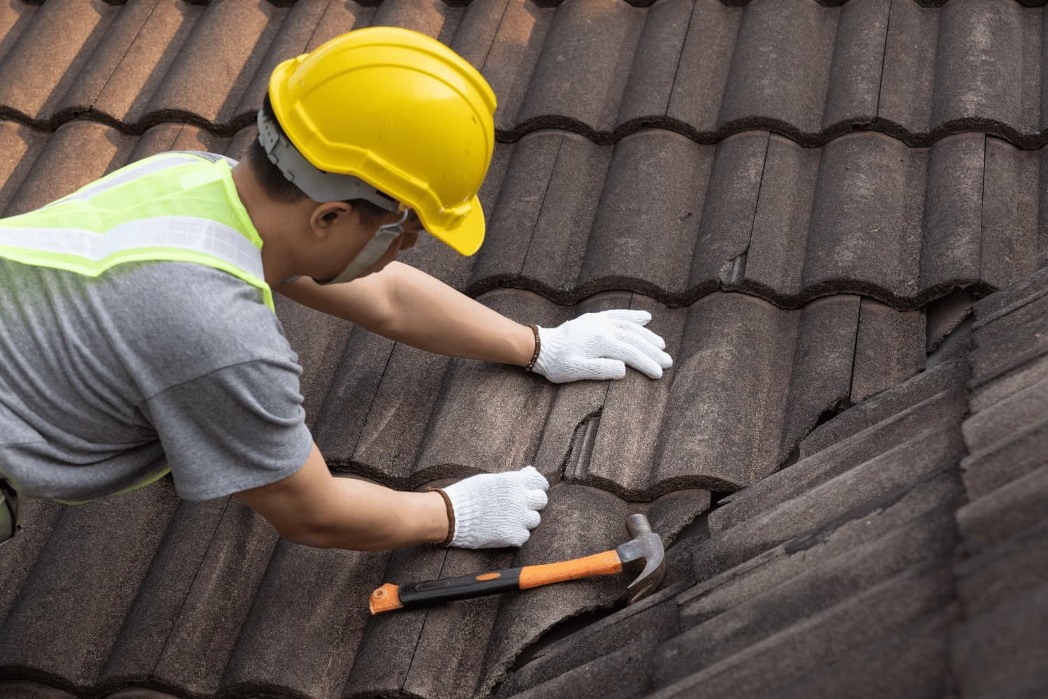 Crew removing old shingles during a roof replacement in Omaha, NE