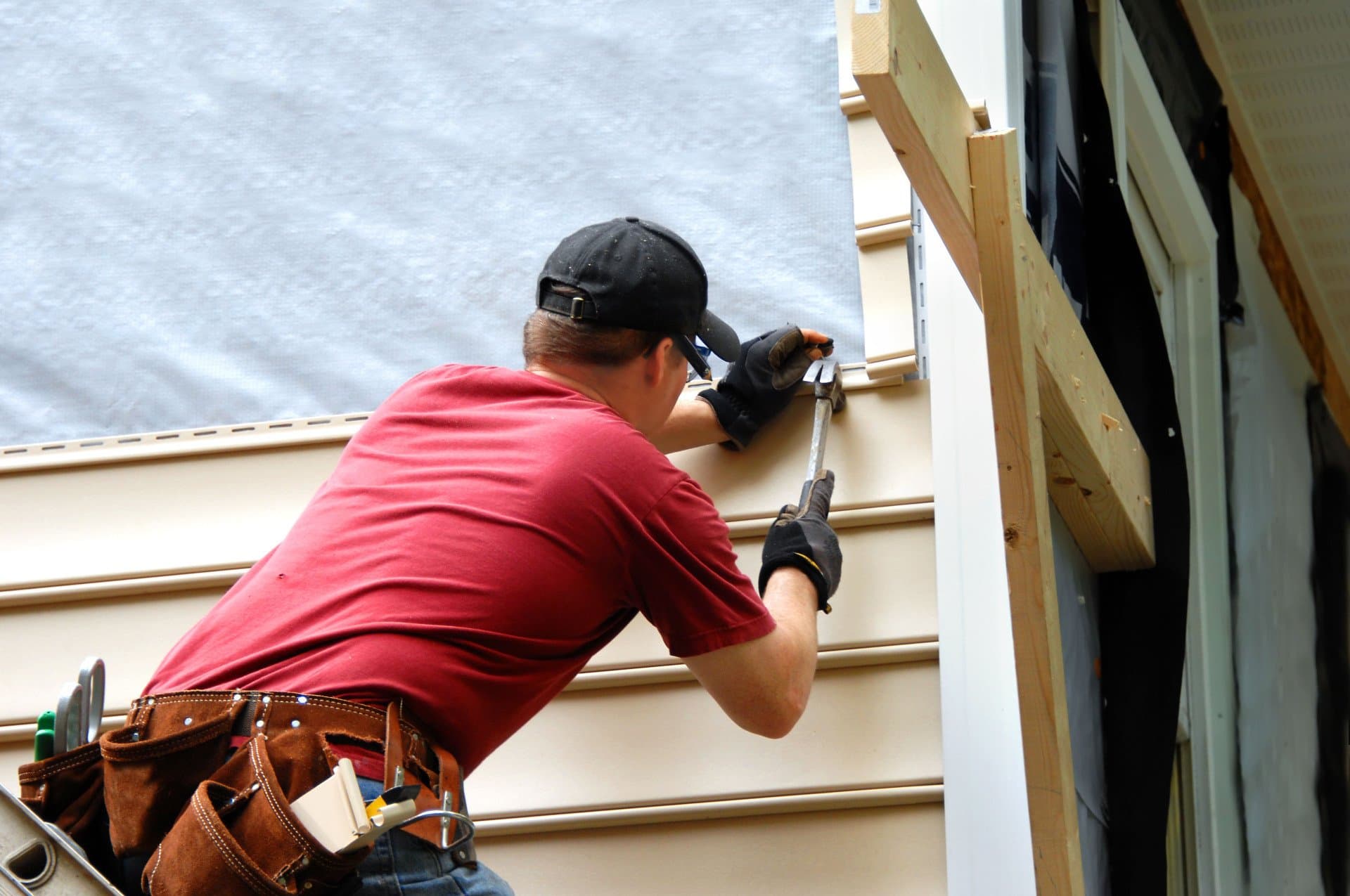 Kutsch Roofing technician detailing siding around a window in Omaha, Nebraska